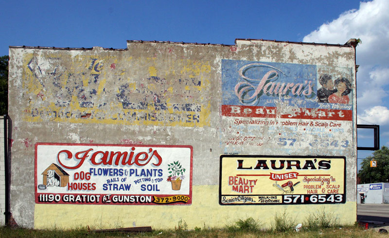Different stages of sign on the same building